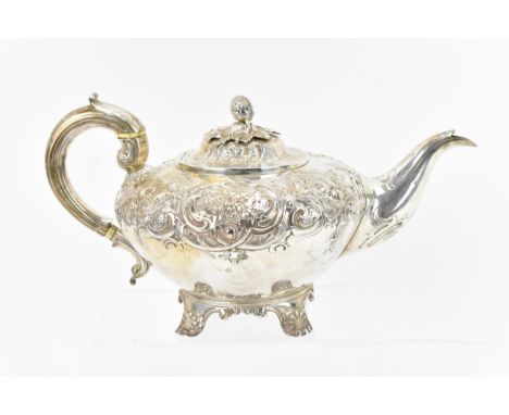 A William IV silver teapot by Richard Pearce & George Burrows, London 1833, designed with embossed and chased foliate and flo
