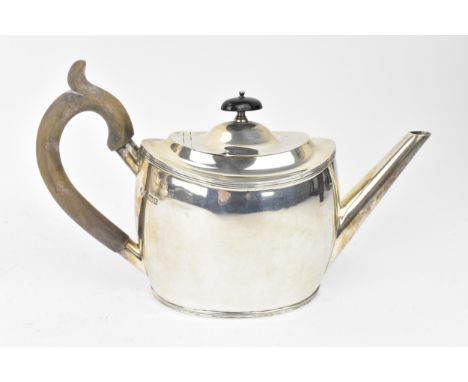 An Edwardian silver teapot by William Hutton &amp; Sons, Sheffield 1909, with wooden handle and finial, boat shaped body, tap