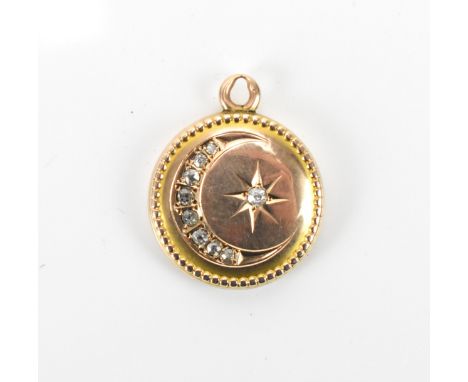 A Victorian/Edwardian yellow metal and diamond inset locket, of circular form with graduated old cut diamonds in a crest and 