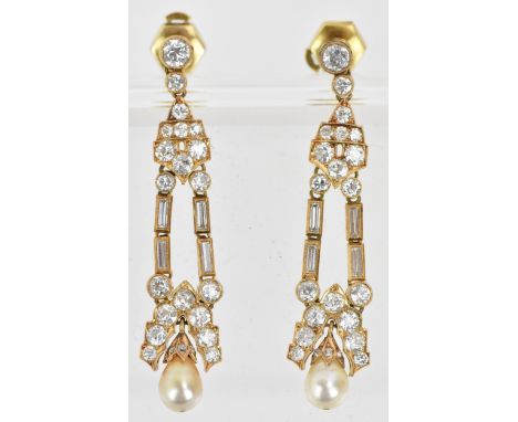 A pair of elegant diamond and pearl drop yellow metal earrings, the pearl set to the bottom of a scalloped edge cap, suspende