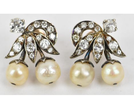 A pair of 1920s diamond and pearl set white metal earrings of flower design each having a brilliant cut diamond in a claw set