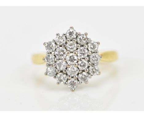 An 18ct yellow gold and diamond snowflake dress ring, set with nineteen brilliant cut diamonds, the shank with two adjusting 