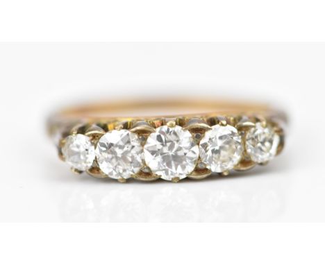 A yellow metal, and five stone diamond ring, set with graduated old cut diamonds, the central one approx 0.25 carat, size P 