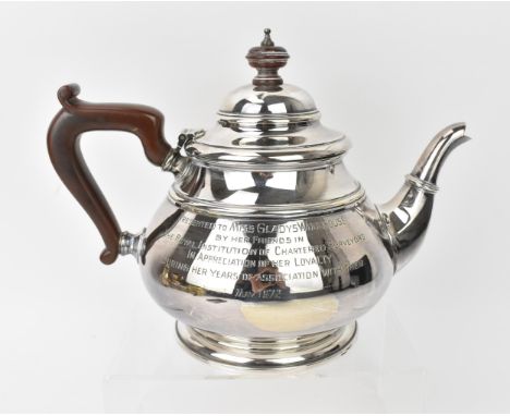 An Elizabeth II Irish silver teapot, Dublin 1972, of bombe form with turned wooden handle and finial, the side with engraved 