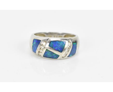 A 14 ct white gold, diamond and black opal ring, of modernist design inset with polished opal and channel set brilliant cut d