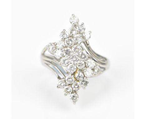 A platinum and diamond dress ring, set with twenty-seven same-sized brilliant cut diamonds in a pierced setting, the shank st