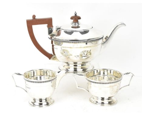 A George V silver three-piece tea set by Mappin &amp; Webb, comprising a teapot, twin-handled sugar bowl, and milk jug, the p