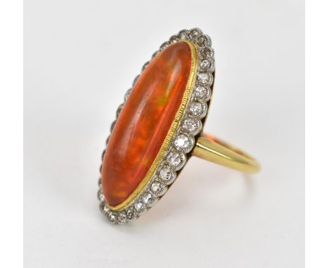 A yellow metal, diamond and fire opal dress ring, of navette form with cabochon oblong opal in a halo of graduated old cut di