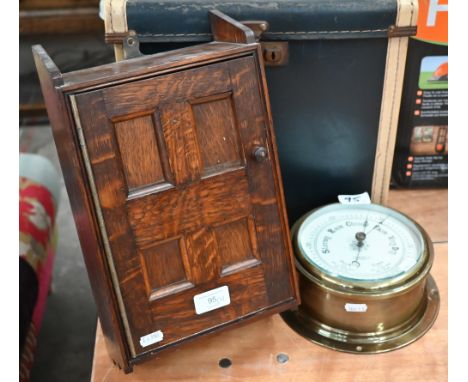 A small oak-panelled wall-mounting medicine cabinet 35 x 21 cm to/w a brass-cased ship's bulkhead aneroid barometer with 14 c