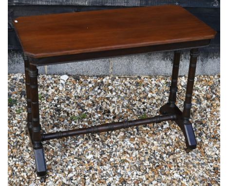 An Edwardian walnut occasional table by James Shoolbred, Tottenham Court Road, the rectangular top with canted corners raised