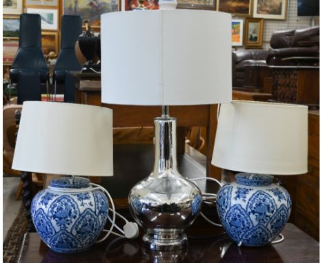 A contemporary silvered glass/chrome table lamp of shaped baluster form with white fabric drum shade, 70 cm high&nbsp; to/w p