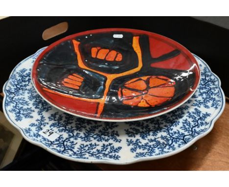 Four vintage blue glass chemists bottles to/w a Poole Volcano charger (repaired), Victorian blue and white pottery lazy Susan