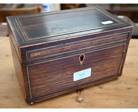 A Georgian rosewood tea caddy with two inner compartments, the lids with bone handles, on brass bun feet, 22 cm wide 