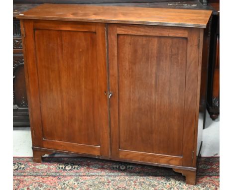 A Victorian mahogany side cabinet with pair of panelled doors enclosing single shelf, raised on bracket feet, 110 cm wide x 3