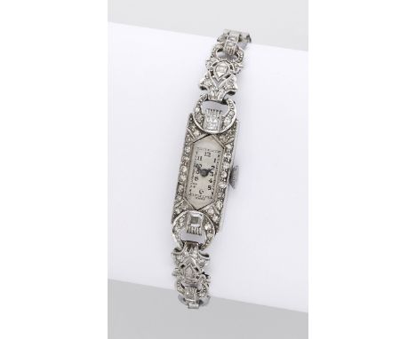 Swiss. A lady’s platinum and diamond-set rectangular cocktail watch, circa 1930. Movement: manual winding, 15 jewels. Dial: s