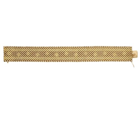 An 18ct gold bracelet by UnoAErre, the broad woven link bracelet, signed, Italian assay marks, length 20cm.  £1,200-£1,500  -