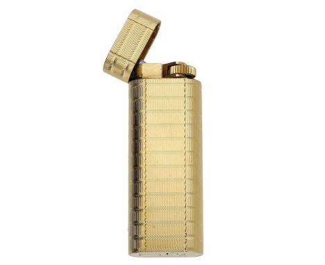 A gold plated lighter by Cartier, of flattened cylindrical section, with reeded engine turn finish, signed ‘Cartier PARIS’ se