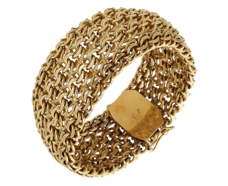 A fancy-link bracelet, the wide strap of woven design, stamped ‘18K’, length 20cm. £3,400-£4,400  ---  Condition Report Clasp
