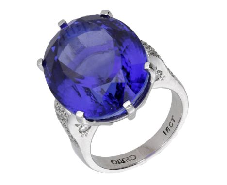 A tanzanite and diamond dress ring, the oval mixed-cut tanzanite in raised claw setting, between diamond pavé set shoulders, 