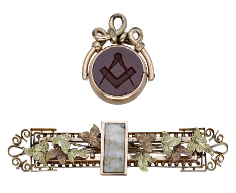 Of Masonic interest: A  hardstone fob seal and a foliate brooch, the gold mounted swivel fob seal engraved with square and co
