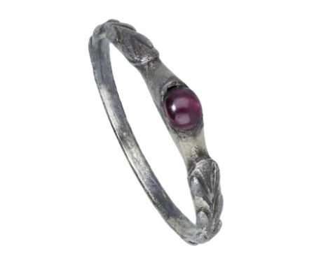 A 14th century silver gilt stirrup ring, the hoop decorated with chevrons, the raised central oval setting with a replacement