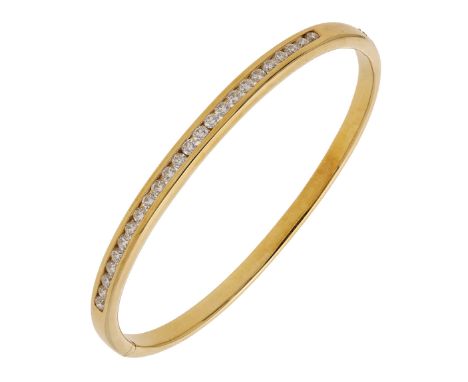 An 18ct gold and diamond set hinged bangle, channel-set to the front with brilliant-cut diamonds, Birmingham hallmark for 200