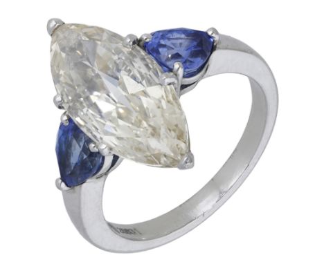 A diamond and sapphire ring by Steltman, the marquise-cut diamond of light brown tint, weighing 3.75 carats, between pear-sha