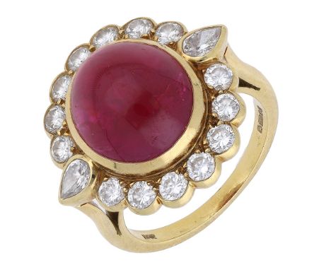 An 18ct gold cabochon ruby and diamond cluster ring, 1988, the ruby cabochon centred within a brilliant-cut and pear-shaped d