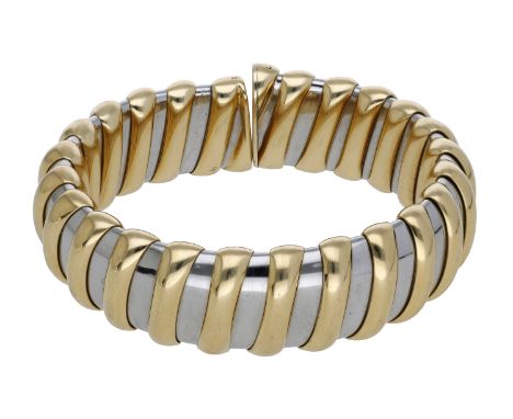 A gold and stainless steel bangle by Bulgari, of ribbed design, signed ‘BVLGARI’, stamped ‘750’, bangle internal diameter app