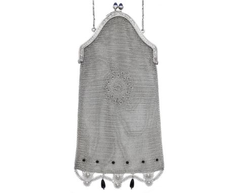 An Art Deco silver mesh link purse, with central pierced motif and black cabochon decoration, terminating in a swag fringe wi