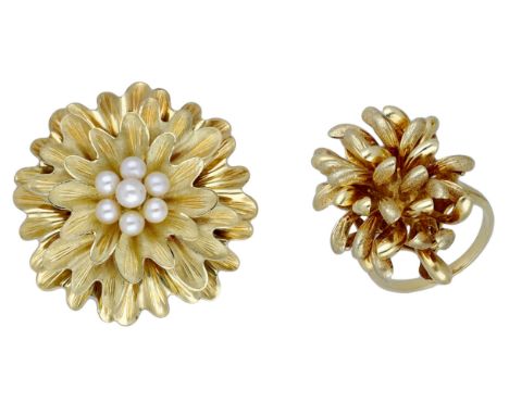 A cultured pearl set flower brooch and a dress ring, the brooch with Florentine finish and centred with a cultured pear clust