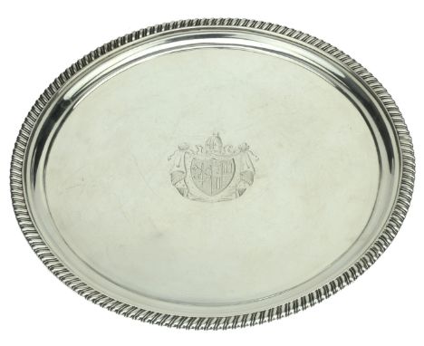A George III silver salver, with gadrooned border, on three gadroon-edged feet, centred with a  draped coat of arms beneath a