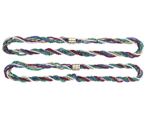 A pair of gem-set torsade necklaces by Kutchinsky, 1983, each five row necklace strung with gold beads, ruby, emerald, sapphi