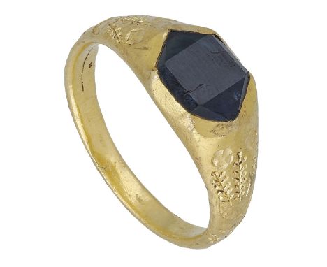 A late Medieval sapphire set ring, 15th century, the rhomb-shaped table-cut sapphire within a six cusped setting between tape