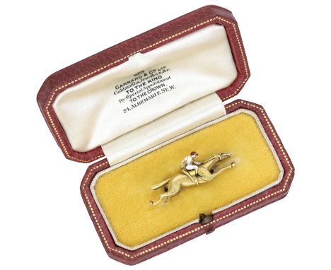Of racing interest: An early 20th century gold and enamel jockey brooch, retailed by Garrard & Co., realistically modelled as