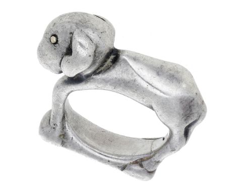 A silver figural ring by Mosheh Oved, circa 1940, the angular design modelled as a lamb, with smooth coat, its head downcast,