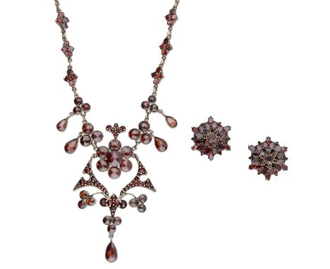 A late 19th century garnet necklace and earring suite, set throughout with vari-cut garnets, the necklace comprising a foliat