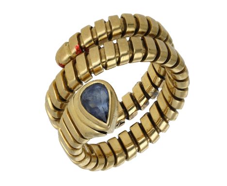 A sapphire ‘Serpenti’ ring by Bulgari, of double coil design, the stylised head set with a pear-cut sapphire, signed ‘BVLGARI