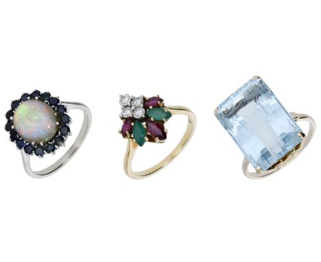 An 18ct gold vari gem-set ring by Kutchinsky, an aquamarine dress ring and an opal cluster ring, the lozenge-shape diamond, r