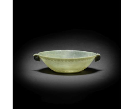 A MUGHAL GREEN JADE BOWLIndia, 18th centuryFinely hollowed as an oval bowl supported on a neat foot encircled by a continuous