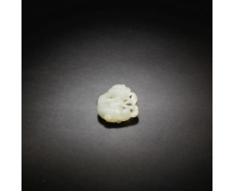 A VERY PALE GREEN JADE CARVING OF A BUDDHIST LION18th centuryThe expertly carved coiled mythical beast with knobbly spine, th