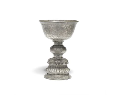 A SILVER-ALLOY BUTTER LAMPTibet, 18th/19th centurySet on a domed flowerhead base with bulbous mid section incised with flower
