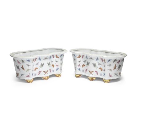 A PAIR OF LARGE FAMILLE ROSE 'HUNDRED BUTTERFLIES' JARDINIÈRESTongzhiEach of 'bat' outline, with deep sides raised on six ruy