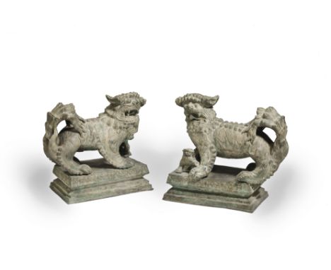 A LARGE PAIR OF METAL-ALLOY BUDDHIST LIONSQing DynastyHeavily cast standing foursquare with large bulbous eyes above open jaw