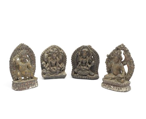 FOUR WOOD CARVINGS OF GUARDIANS AND DEITIESTibet and Nepal, 17th/18th centuryIncluding Mahakala, Chamunda and Shiva, each on 