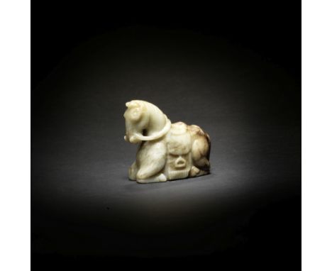 A PALE GREEN AND RUSSET JADE CARVING OF A HORSEMing DynastyThe horse carved kneeling with its legs tucked beneath the large b