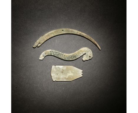 THREE ARCHAIC JADE CARVINGSEastern Zhou/Han DynastyComprising a stylised dragon pendant of S-shape with a dragon head and car