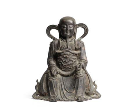 A LARGE DOCUMENTARY BRONZE FIGURE OF ZHENWUMing DynastyThe Daoist deity cast seated, wearing over his armour long flowing rob