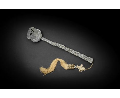 A GREYISH-GREEN JADE RUYI SCEPTRE18th/19th centuryCrisply carved along the shaft with gnarled branches of pine, lingzhi fungu