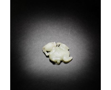 A PALE GREEN JADE CARVING OF A TOAD AND POMEGRANATE18th centuryNaturalistically carved as a large, plump toad with beady eyes